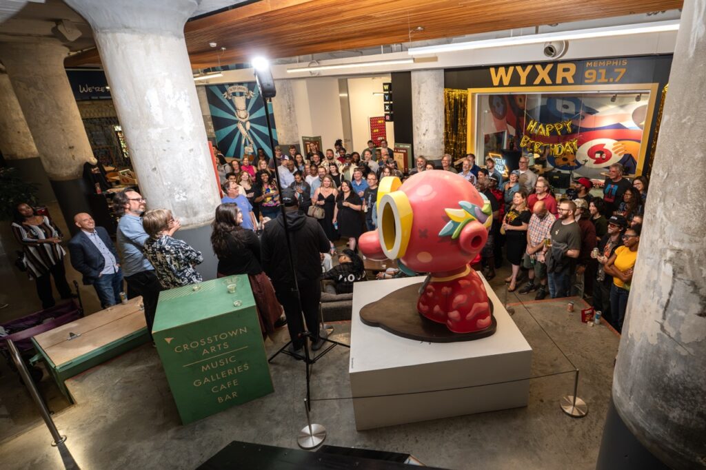 High-angle view of the crowd gathered around the pink sculpture during the program.