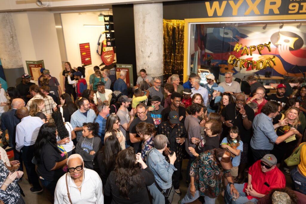 High-angle view of the crowd filling the atrium in front of the WYXR studio window.