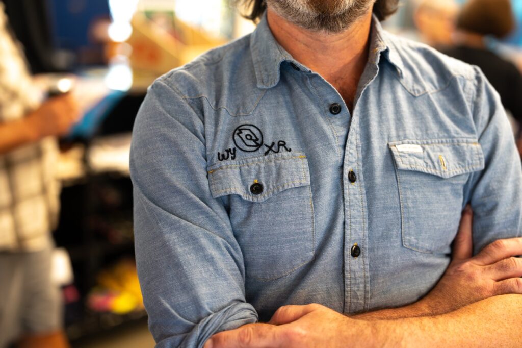 Close-up of a chambray work shirt with the WYXR logo embroidered on the chest.