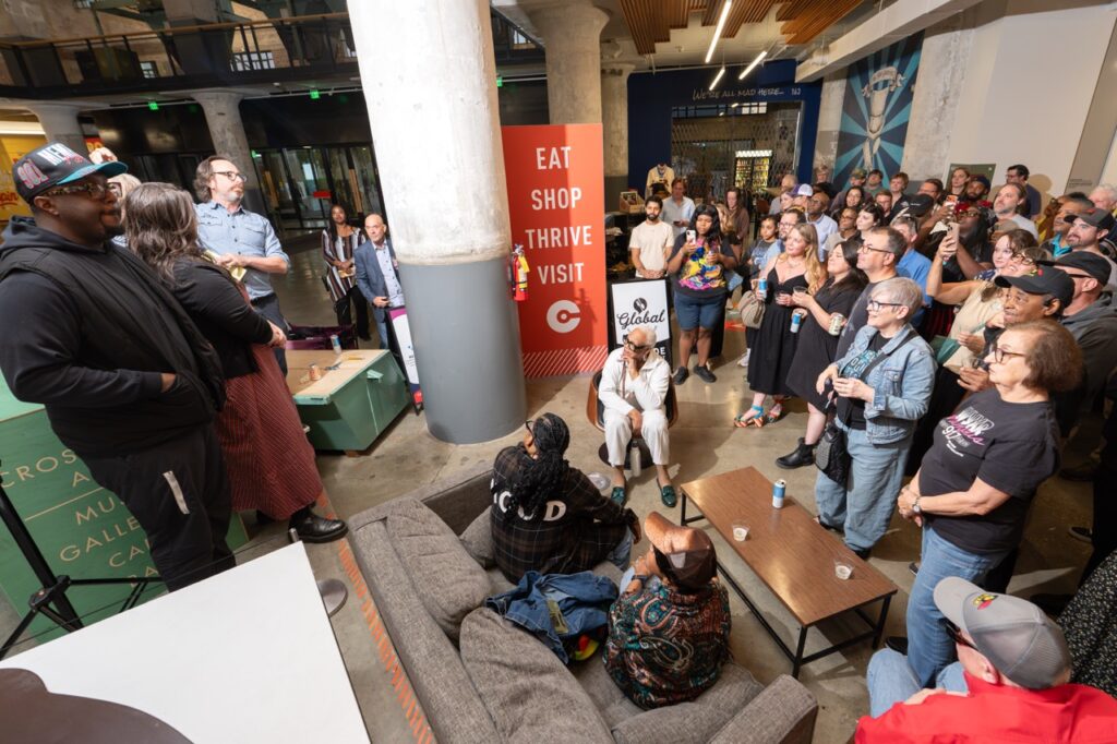 Guests gather in a loose circle to watch the speakers.